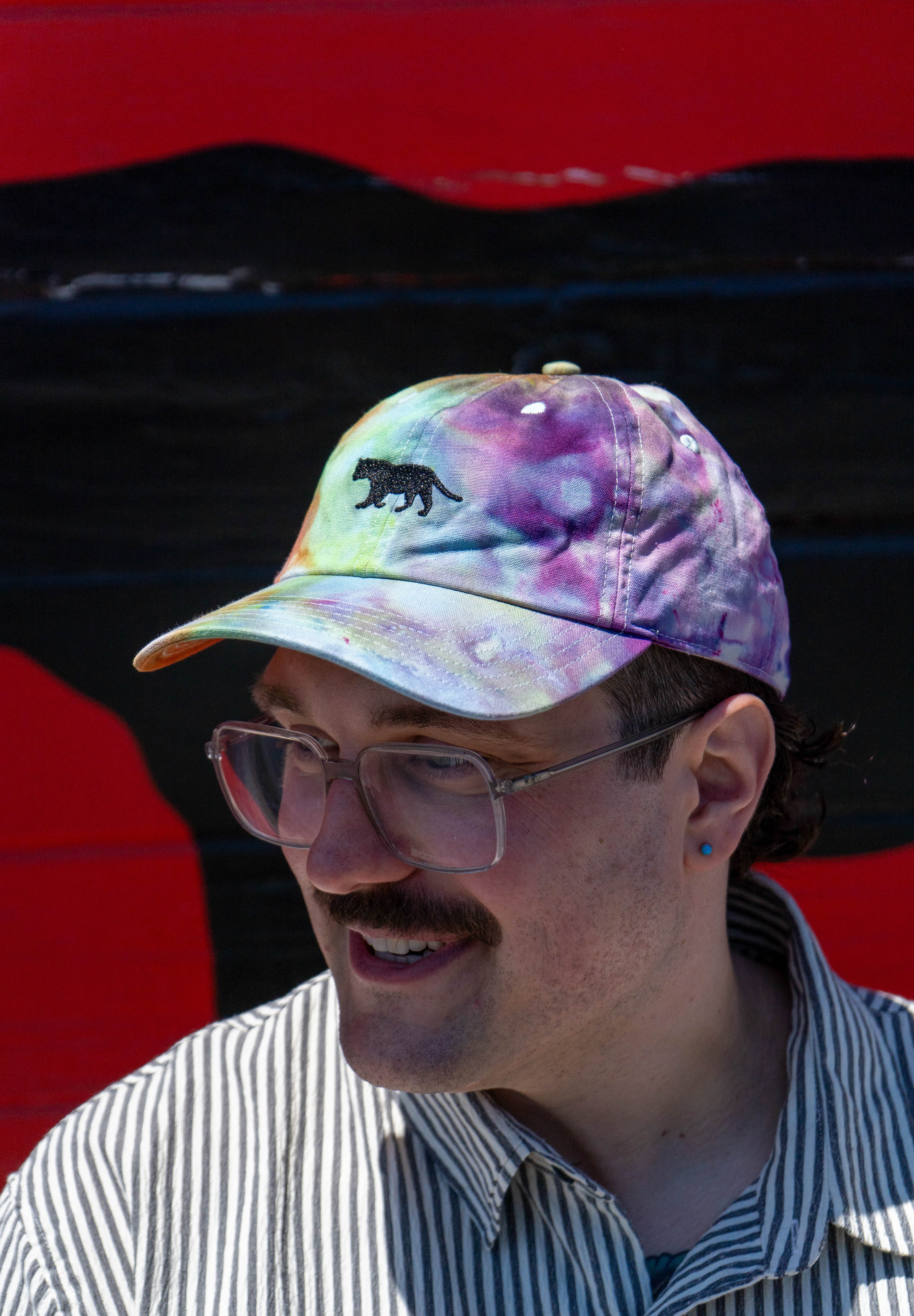 Person wearing Equator Coffees Pride Hat | Equator Coffees