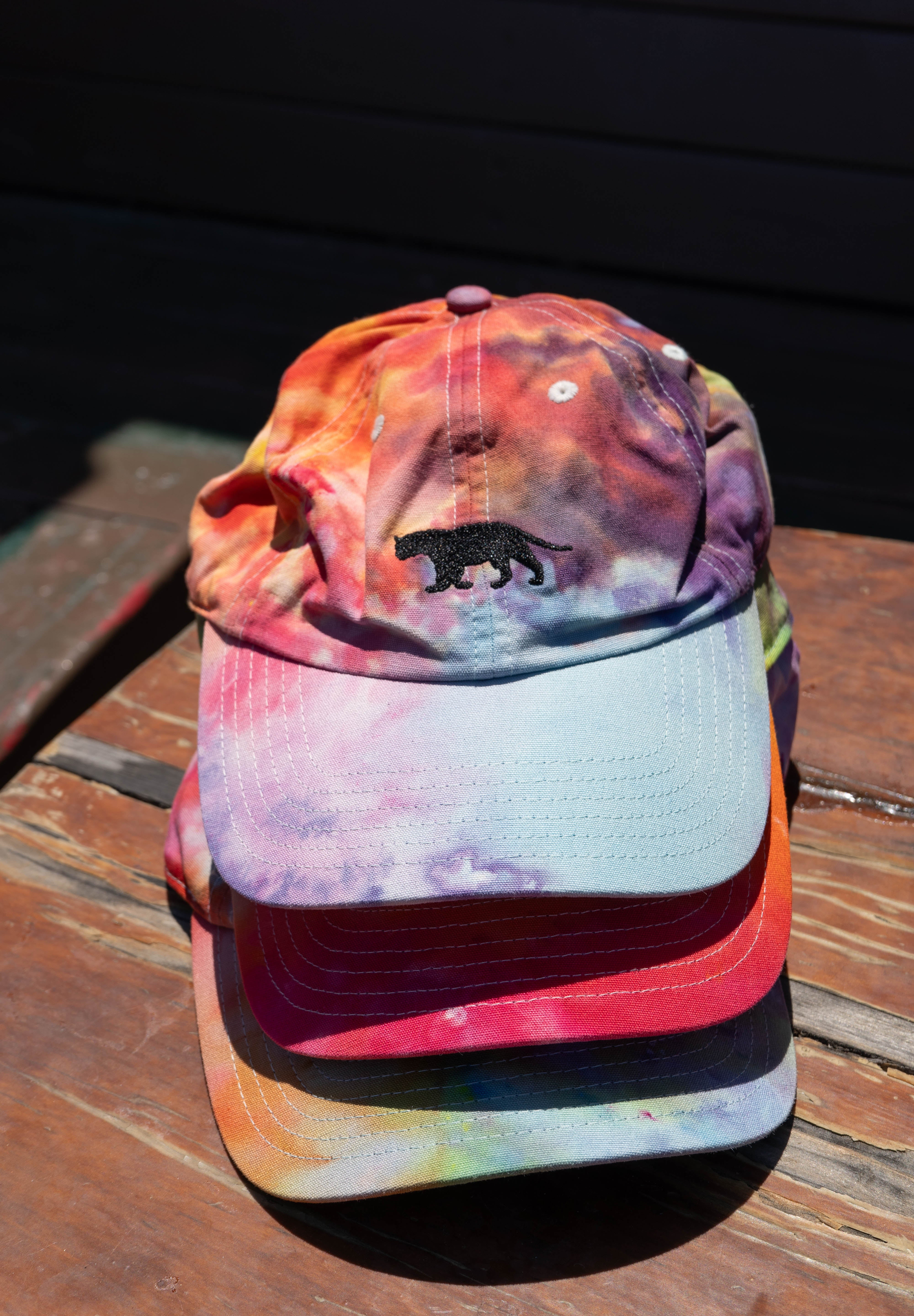 Stack of Equator Coffees Pride Hats | Equator Coffees