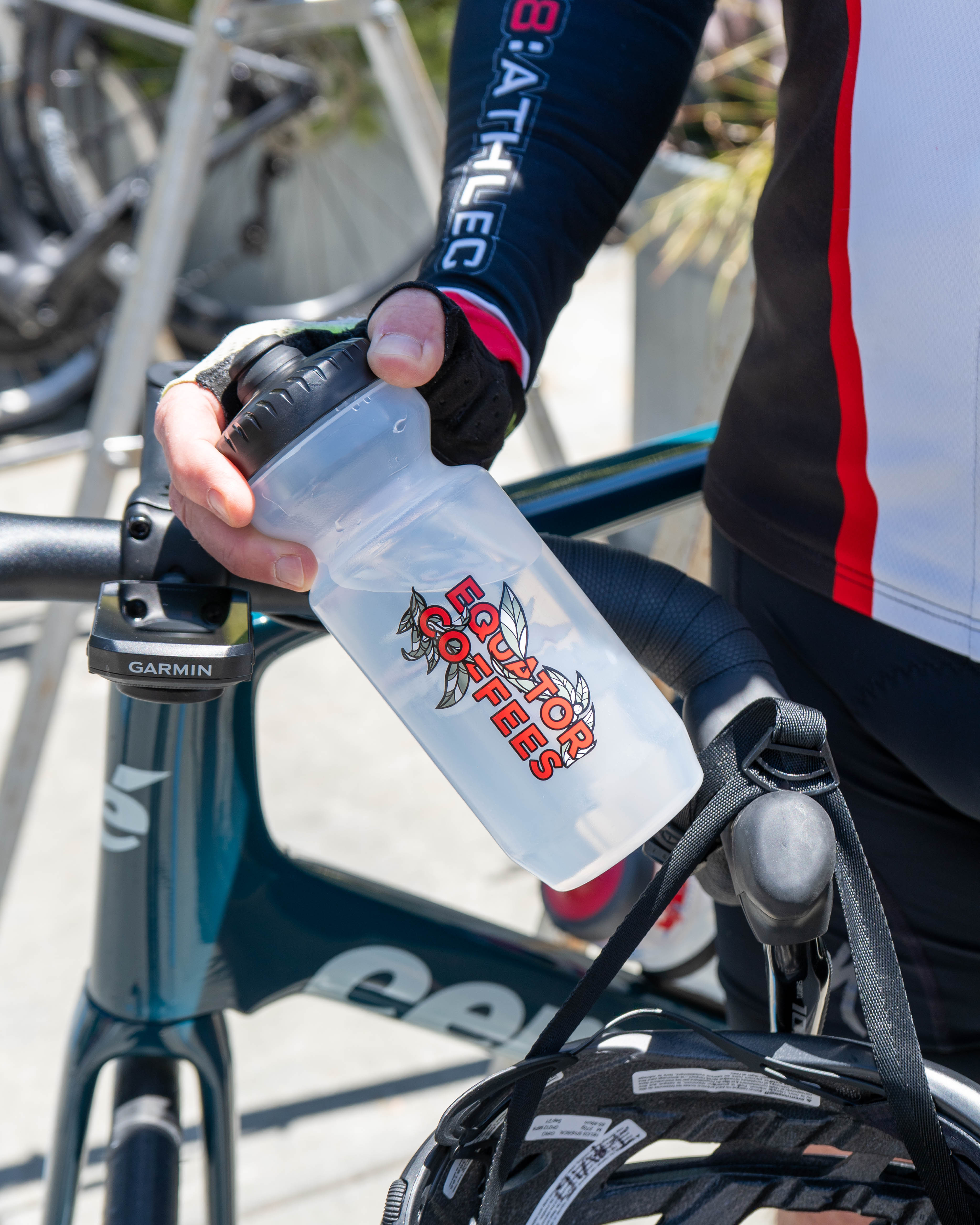 Person holding a Equator Coffees water bottle | Equator Coffees