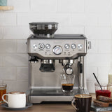 The Breville Barista Express Espresso Machine pulling a shot of espresso on the kitchen counter | Equator Coffees