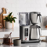 Breville Luxe Thermal Brewer at home on the kitchen counter with ground coffee and a ceramic mug | Equator Coffees