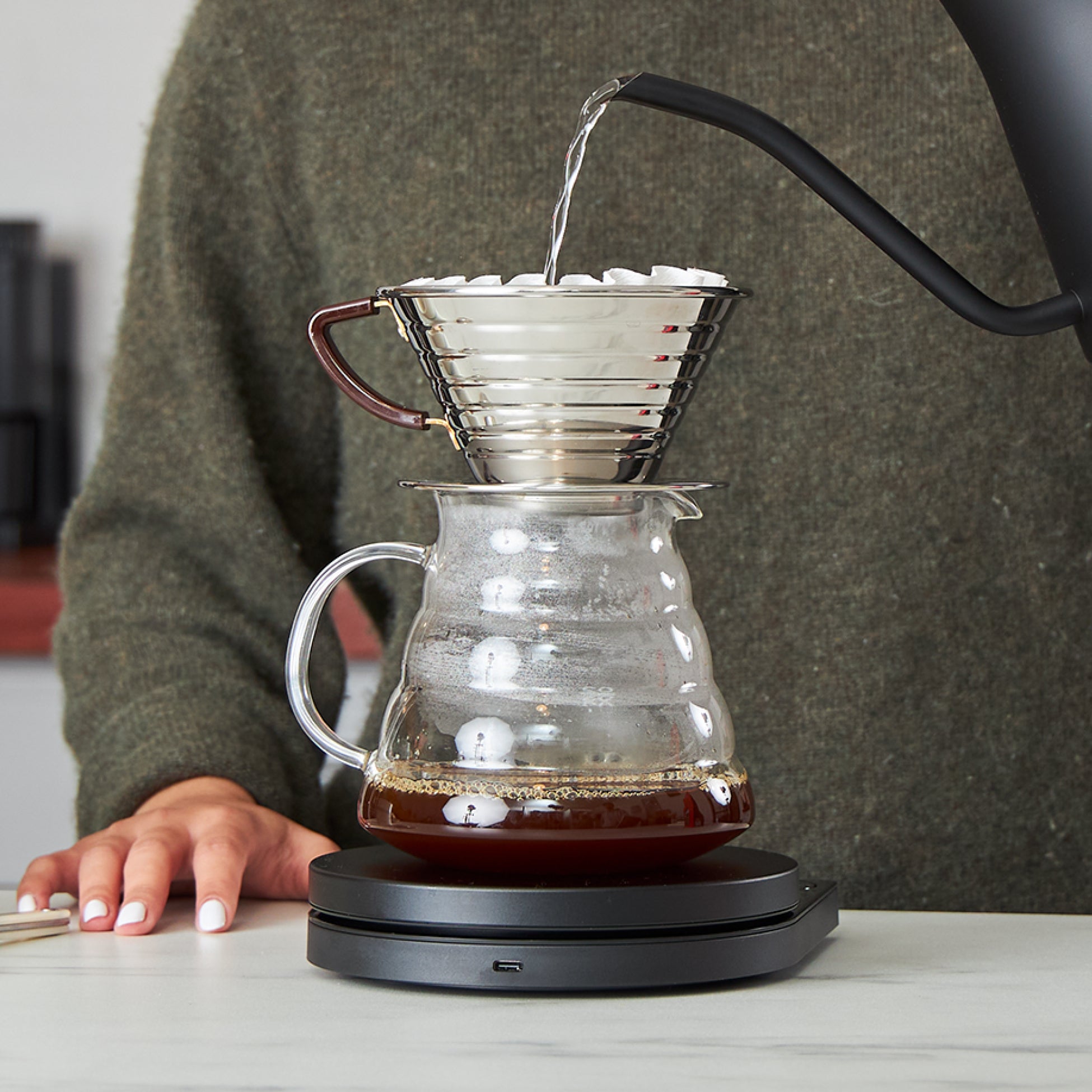 Person brewing coffee with a Kalita Wave dripper
