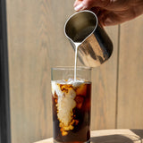 Adding cream to a cold brew coffee on a hot day | Equator Coffees