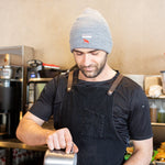 Equator Grey Tab Beanie | Grey Winter Beanie | Equator Barista wearing a grey beanie | Equator Coffees