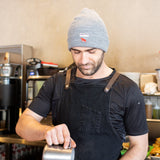 Equator Grey Tab Beanie | Grey Winter Beanie | Equator Barista wearing a grey beanie | Equator Coffees