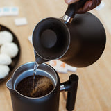 Pouring hot water into the Fellow Clara French Press for brewing | Equator Coffees