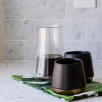 Fellow Stagg Double Wall Carafe | Fellow Coffee Carafe | Fellow Coffee Pitcher is ready to serve with two black mugs | Equator Coffees