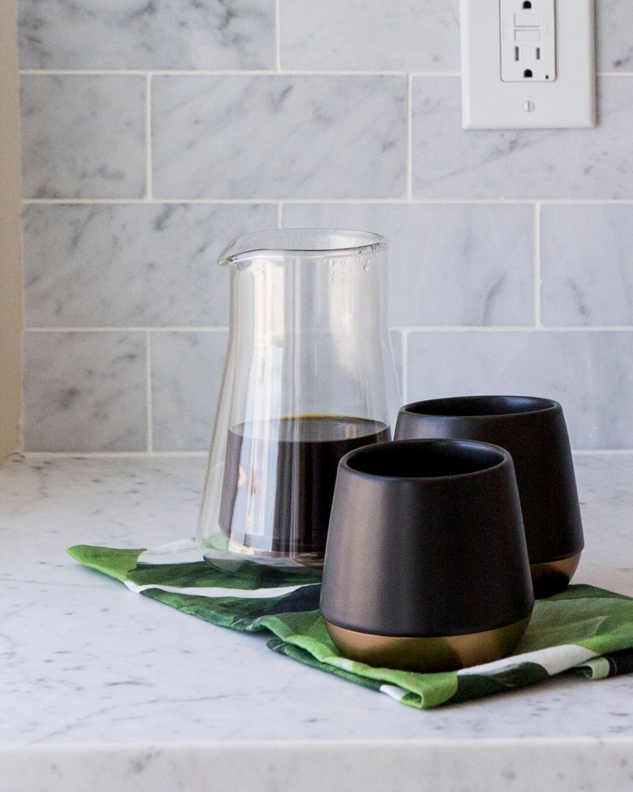 Fellow Stagg Double Wall Carafe | Fellow Coffee Carafe | Fellow Coffee Pitcher is ready to serve with two black mugs | Equator Coffees