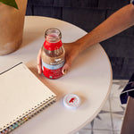 Opening up a refreshing bottle of Hint of Vanilla Organic Cold Brew Coffee tfor an outdoor study session | Equator Coffees
