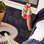 Enjoying a refreshing bottle of Hint of Vanilla Organic Cold Brew Coffee during an outdoor study session | Equator Coffees