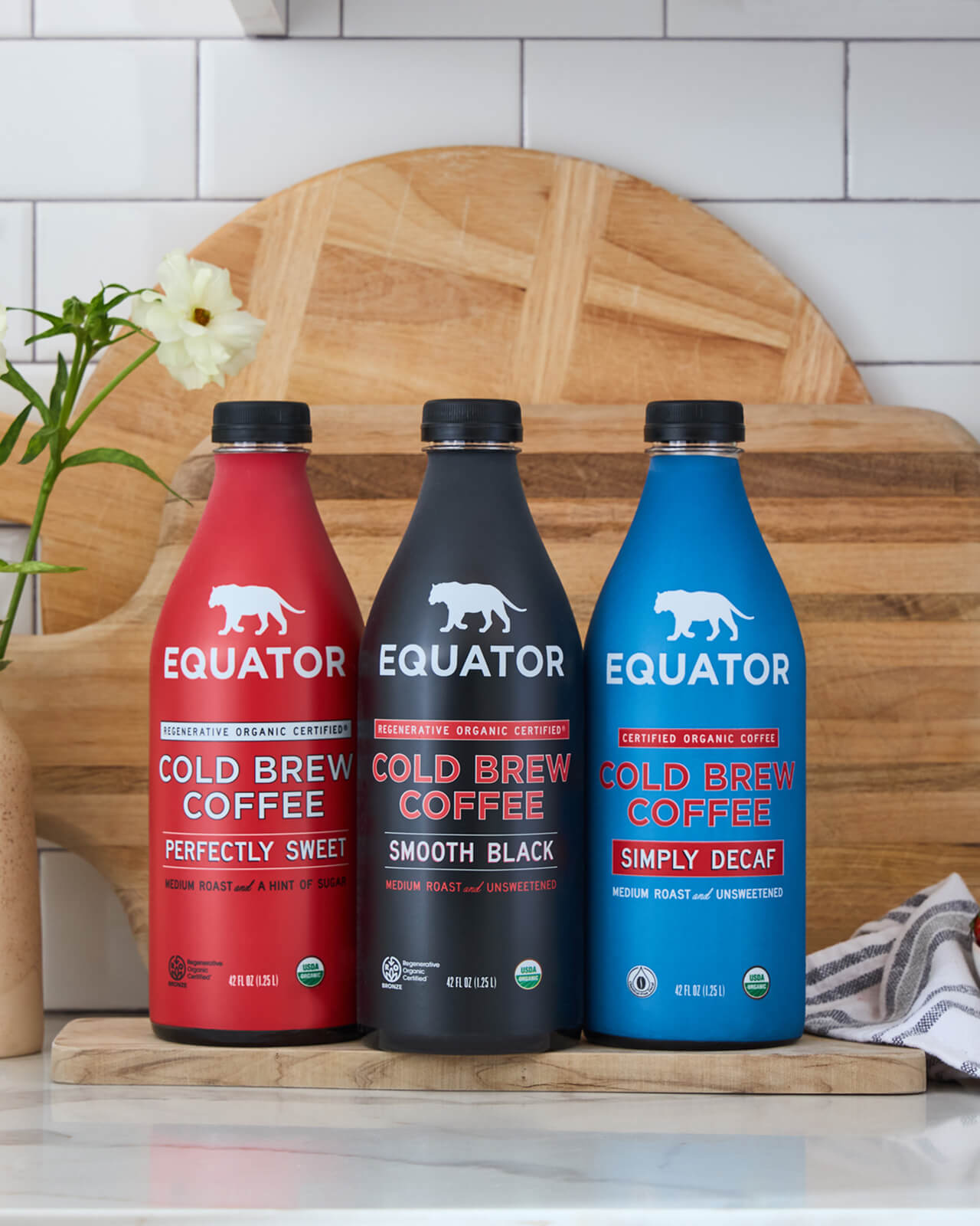 An ensemble of 42 fl oz bottles of Equator cold brew coffees: Perfectly Seet, Smooth Black, and Simply Decaf | Equator Coffees