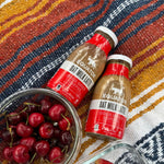 Preparing a pair of Oat Milk Latte Organic Cold Brew Coffees to enjoy at a summer picnic | Equator Coffees