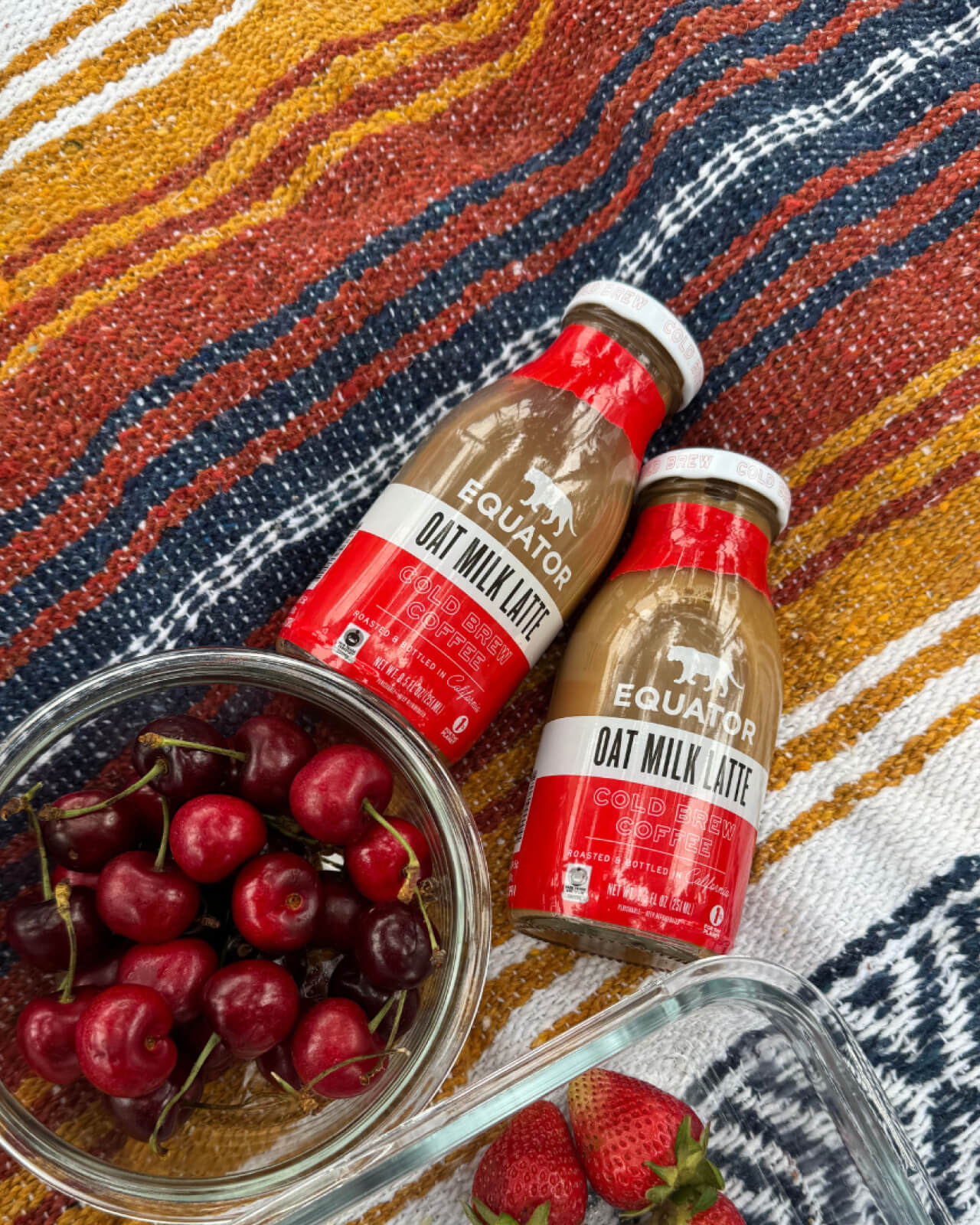 Preparing a pair of Oat Milk Latte Organic Cold Brew Coffees to enjoy at a summer picnic | Equator Coffees