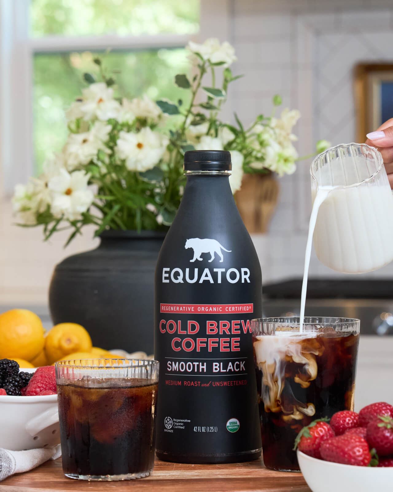 Smooth Black Organic Cold Brew Coffee | Serving up delicious cold brew coffee with cream and a side of strawberries | Equator Coffees