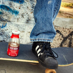Taking a bottle of Velvet Mocha Organic Cold Brew Coffee on the go with a skateboard | Equator Coffees