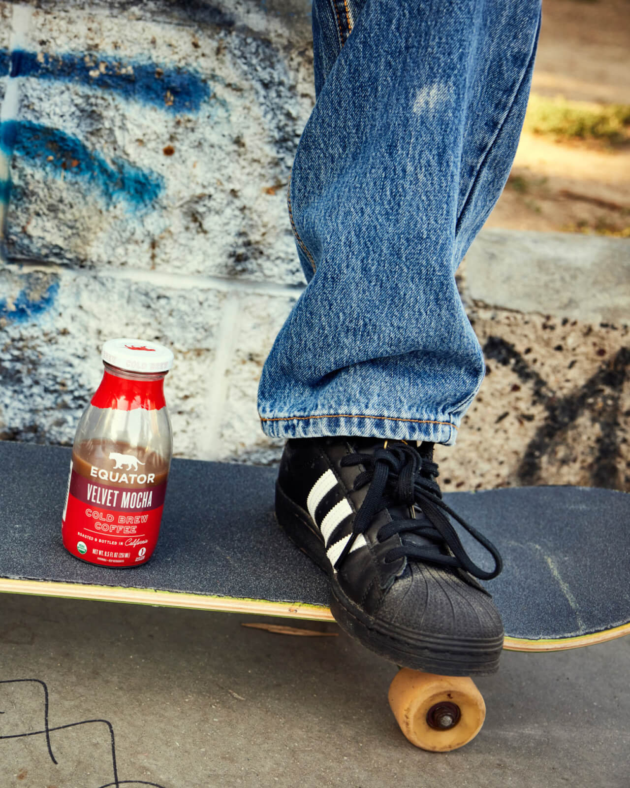 Taking a bottle of Velvet Mocha Organic Cold Brew Coffee on the go with a skateboard | Equator Coffees
